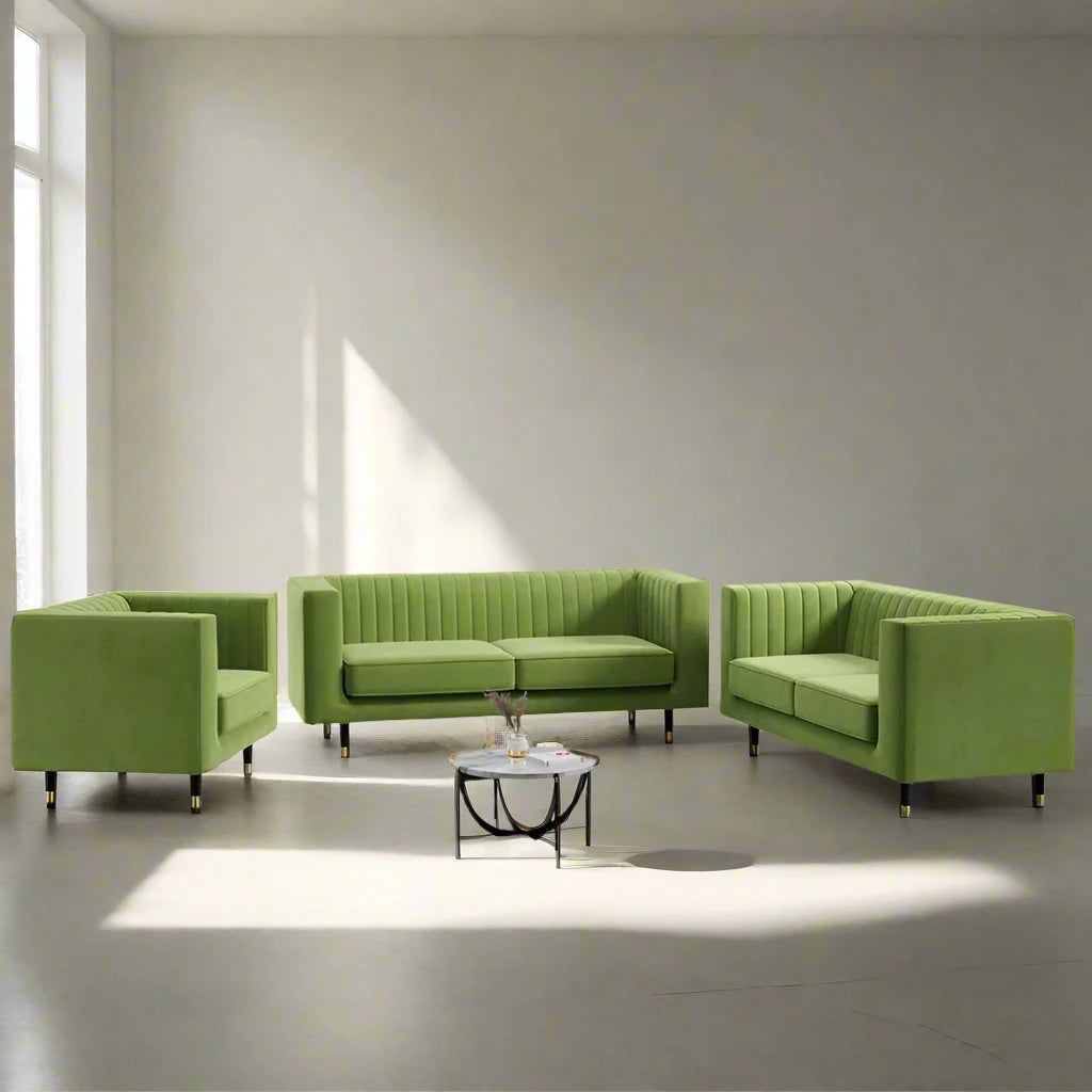Green sofa set in a modern room with large windows.